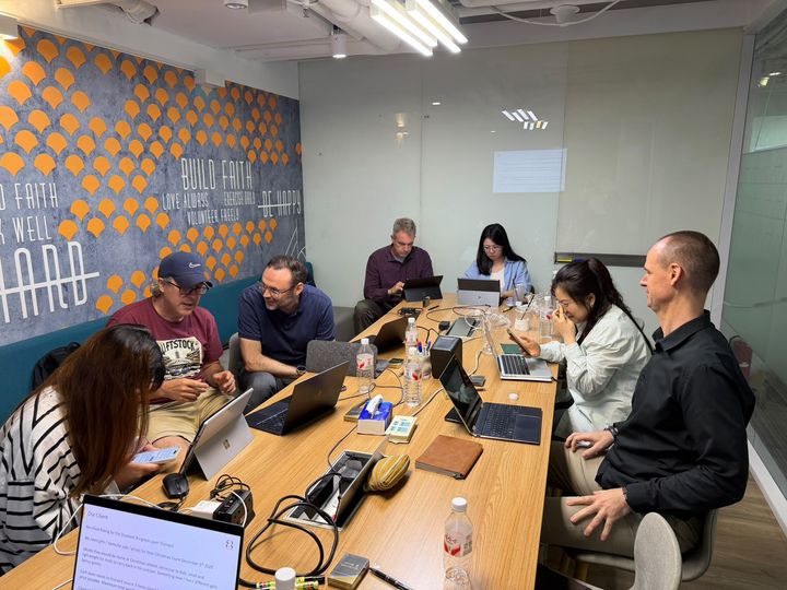 A team working with laptops in a practical AI workshop