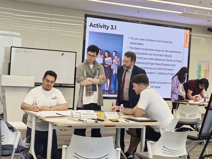 Managers working through a group exercise at a leadership workshop