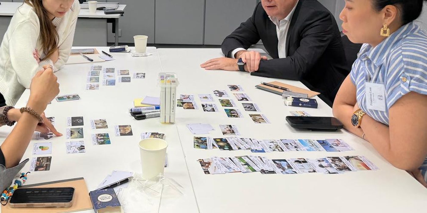 Andy Clark coaching a small group at a table during a ClarkMorgan workshop